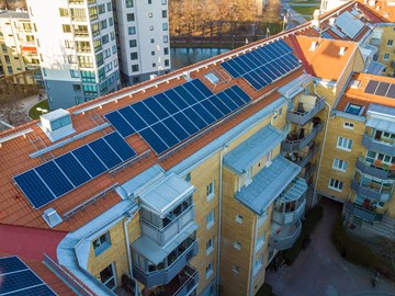 Aerial view of solar photo voltaic panels system on apartment building roof. Renewable ecological green energy production concept. Aerial view of solar photo voltaic panels system on apartment building roof. Renewable ecological green energy production concept.