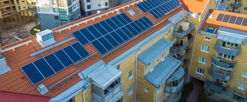 Aerial view of solar photo voltaic panels system on apartment building roof. Renewable ecological green energy production concept. Aerial view of solar photo voltaic panels system on apartment building roof. Renewable ecological green energy production concept.